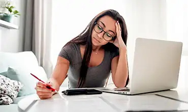 woman working on forms with pencil and paper